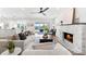 Open living room with a water view, fireplace, and modern furnishings and light colored decor at 517 Belle Isle Ave, Belleair Beach, FL 33786