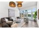 Modern living room featuring ample natural light, stylish furnishings, and stunning waterfront views at 517 Belle Isle Ave, Belleair Beach, FL 33786