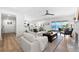Bright, modern living room with water views, kitchen access, and neutral decor at 517 Belle Isle Ave, Belleair Beach, FL 33786