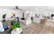 Open living space with modern decor, including a fireplace, kitchen, and hardwood floors at 517 Belle Isle Ave, Belleair Beach, FL 33786