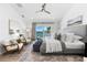 Inviting primary bedroom boasts a water view, ceiling fan and decorative rug at 517 Belle Isle Ave, Belleair Beach, FL 33786