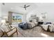 Spacious primary bedroom with ceiling fan, accent chairs and water view at 517 Belle Isle Ave, Belleair Beach, FL 33786