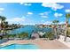 Waterfront property features an inviting pool and a private boat dock with stunning views of the bay at 517 Belle Isle Ave, Belleair Beach, FL 33786