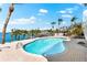 Private backyard pool and dock with beautiful views of the intercoastal waterway surrounded by lush greenery at 517 Belle Isle Ave, Belleair Beach, FL 33786