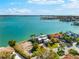 Breathtaking waterfront home showcasing a picturesque coastline, city skyline and lush greenery surrounding the property at 520 Belle Isle Ave, Belleair Beach, FL 33786