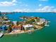 Waterfront property boasting a lush yard, private dock, and outdoor pool, with stunning water views and a distant city skyline at 520 Belle Isle Ave, Belleair Beach, FL 33786