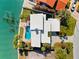 Waterfront property featuring a pool and private dock, surrounded by mature palms, offering serene waterside living at 520 Belle Isle Ave, Belleair Beach, FL 33786