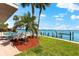 Enjoy the outdoors with this bayside backyard, pool, and private dock at 520 Belle Isle Ave, Belleair Beach, FL 33786
