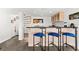 Stylish bar area features seating, wet bar, storage and a unique spiral staircase in an open floor plan at 520 Belle Isle Ave, Belleair Beach, FL 33786