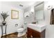 Bathroom featuring a modern sink, vanity, stylish mirror and unique tile flooring at 520 Belle Isle Ave, Belleair Beach, FL 33786