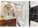 Well-lit bathroom featuring a glass vessel sink and black marble shower at 520 Belle Isle Ave, Belleair Beach, FL 33786