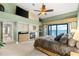 Inviting main bedroom with fireplace and a door leading to a waterfront balcony at 520 Belle Isle Ave, Belleair Beach, FL 33786