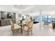 Spacious dining area flowing to living area, with view of waterfront and swimming pool at 520 Belle Isle Ave, Belleair Beach, FL 33786