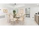 Open dining area featuring seating for six, modern lighting, and ample natural light at 520 Belle Isle Ave, Belleair Beach, FL 33786