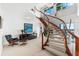 Bright entryway featuring a curved staircase with wood and glass railing, and modern decor at 520 Belle Isle Ave, Belleair Beach, FL 33786