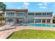 Stunning waterfront home with a private pool, spiral staircase, and ample outdoor seating at 520 Belle Isle Ave, Belleair Beach, FL 33786