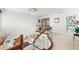 Elegant foyer features a curved wood and glass staircase, modern lighting, and a view of the living area below at 520 Belle Isle Ave, Belleair Beach, FL 33786