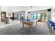 Elegant game room features water views, stylish furnishings, and a pool table, perfect for entertaining at 520 Belle Isle Ave, Belleair Beach, FL 33786