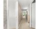 Long hallway featuring neutral colors, with doorways on either side, and carpeted flooring at 520 Belle Isle Ave, Belleair Beach, FL 33786