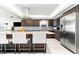 Modern kitchen with large island seating, granite countertops, stainless steel appliances, and mosaic backsplash at 520 Belle Isle Ave, Belleair Beach, FL 33786