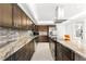 A modern kitchen features stainless steel appliances, granite countertops, and a mosaic tile backsplash at 520 Belle Isle Ave, Belleair Beach, FL 33786