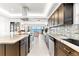 Modern kitchen with island seating, granite countertops and stainless steel appliances, beautiful water views at 520 Belle Isle Ave, Belleair Beach, FL 33786