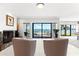 Bright living room with view of waterfront, pool, and sliding glass doors for easy access at 520 Belle Isle Ave, Belleair Beach, FL 33786