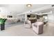 Spacious open-concept living space with pool table, seating, kitchen, and wet bar with tv at 520 Belle Isle Ave, Belleair Beach, FL 33786