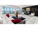 Stylish living room with floor-to-ceiling windows offering panoramic waterfront views, modern decor and fireplace at 520 Belle Isle Ave, Belleair Beach, FL 33786