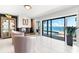 Living room featuring waterfront view, access to pool area, and elegant furnishings at 520 Belle Isle Ave, Belleair Beach, FL 33786