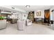 Open-concept living space with marble fireplace, seating area, and access to the kitchen with island seating at 520 Belle Isle Ave, Belleair Beach, FL 33786