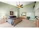 This spacious main bedroom features a ceiling fan and elegant furnishings, offering a relaxing retreat at 520 Belle Isle Ave, Belleair Beach, FL 33786