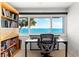 This office space offers desk and shelving, with stunning waterfront views from the expansive windows at 520 Belle Isle Ave, Belleair Beach, FL 33786