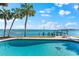 Enjoy the view from the pool with a turtle mosaic, palm trees, and easy access to the dock at 520 Belle Isle Ave, Belleair Beach, FL 33786
