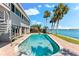 Enjoy the waterfront view in your private pool with access to backyard amenities and dock at 520 Belle Isle Ave, Belleair Beach, FL 33786