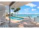 Enjoy outdoor dining by the pool while enjoying the bay views from this Florida dream home at 520 Belle Isle Ave, Belleair Beach, FL 33786