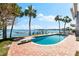 Breathtaking waterfront views from the pool with diving board and hammock for ultimate relaxation at 520 Belle Isle Ave, Belleair Beach, FL 33786