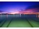 Mesmerizing night view of the water with city lights reflecting on the calm surface at 520 Belle Isle Ave, Belleair Beach, FL 33786