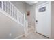 Bright foyer with white staircase and door leading to the home's interior at 6867 Citrus Creek Ln, Tampa, FL 33625