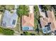 Aerial view of a single-story home with tile roof and screened in pool in a residential neighborhood at 7581 Palmer Glen Cir, Sarasota, FL 34240