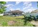 This backyard has a pool, a screened in porch and nice seating at 7581 Palmer Glen Cir, Sarasota, FL 34240