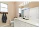 Well-lit bathroom featuring a white vanity with a large mirror and neutral walls at 7581 Palmer Glen Cir, Sarasota, FL 34240