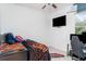 Clean bedroom with television mounted on wall, desk, and carpeted floor at 7581 Palmer Glen Cir, Sarasota, FL 34240