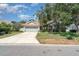 Charming single-story home featuring a well-maintained lawn, mature tree, and a two-car garage at 7581 Palmer Glen Cir, Sarasota, FL 34240