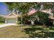 Charming single-story home with lovely lawn and landscaping, mature tree, and a two-car garage at 7581 Palmer Glen Cir, Sarasota, FL 34240