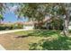 Single-story home with mature landscaping and a well maintained front lawn at 7581 Palmer Glen Cir, Sarasota, FL 34240