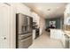 Kitchen view with stainless steel appliances, tile flooring, and white cabinetry at 7581 Palmer Glen Cir, Sarasota, FL 34240