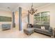 Inviting living room showcasing tile floors, neutral paint, arched entryway, and ample natural light at 7581 Palmer Glen Cir, Sarasota, FL 34240