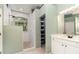 Main bathroom featuring tiled walk-in shower, vanity, and walk-in closet at 7581 Palmer Glen Cir, Sarasota, FL 34240