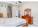 Main bedroom features wood furniture, tray ceiling and ensuite bath at 7581 Palmer Glen Cir, Sarasota, FL 34240